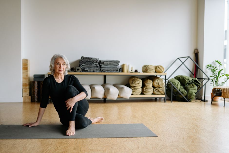 A student resting in a supported yin yoga pose